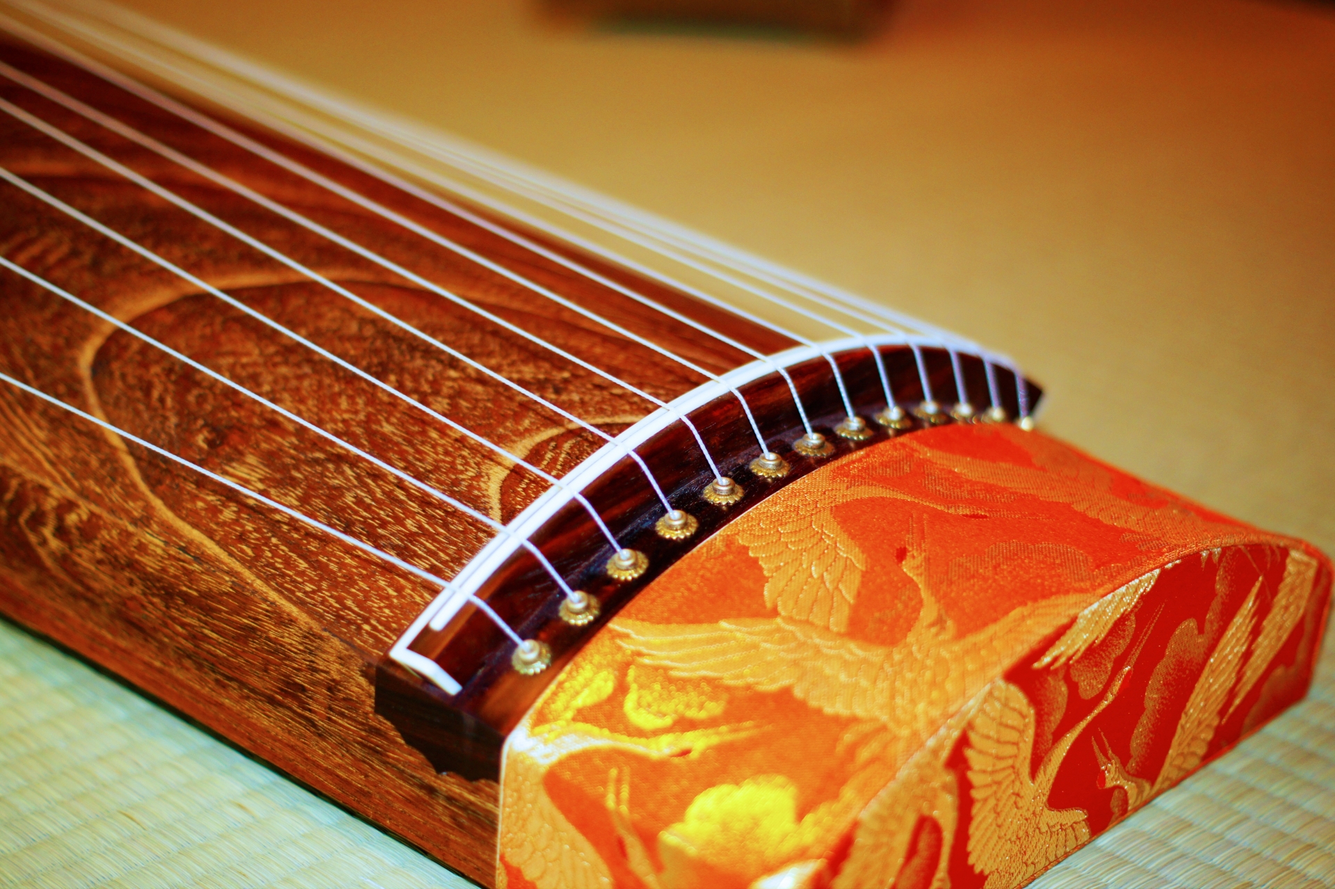 Close-up of the wood grain and decorative details of a Japanese koto